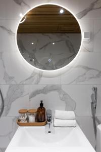 a bathroom with a sink and a mirror at Arctic Night City Suite in Rovaniemi