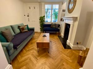 a living room with a couch and a coffee table at Camelford Street Cottage - Brighton in Brighton & Hove
