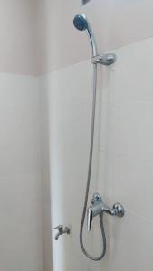 łazienka z prysznicem z głowicą prysznicową w obiekcie PURNAMA HOUSE KUTA w mieście Kuta