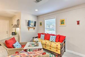 a living room with a couch and red pillows at Cedar Creek Escape with Gas Grill and Fire Pit! in Tool