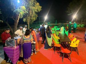 a group of people standing around a table and chairs at Creek Forest - Riverside Boutique Resort in Rishīkesh +66 photos