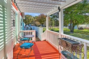 a porch with two chairs and a table at Cedar Creek Escape with Gas Grill and Fire Pit! in Tool