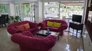 a living room with two couches and a table at Panormos Hotel in Didim