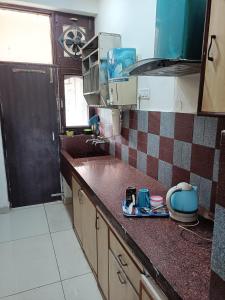 a kitchen with a sink and a counter top at Chandigarh home in Chandīgarh