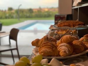 a table topped with plates of pastries and grapes at B&B Lough in Colà di Lazise