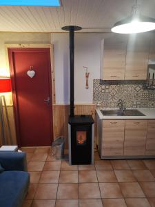 een keuken met een houtkachel in een kamer bij Ha Py Chalet in Campan