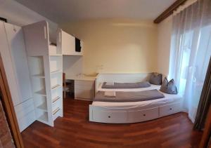 a bedroom with a bed and a book shelf at Arca 2 in Leukerbad