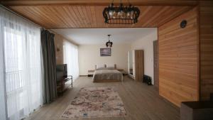 a bedroom with a bed and a chandelier at Boutique Villas Murgavets Pamporovo in Pamporovo