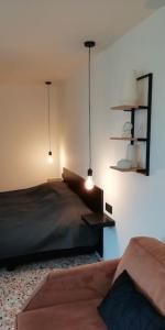 a bedroom with a bed and two lights on the wall at Dreve14 in Staden