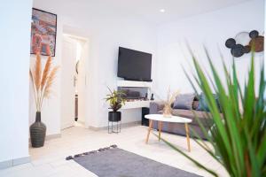 sala de estar con sofá y TV en SunStone Apartment en Fira