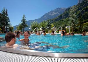 a group of people in a swimming pool at Arca 2 in Leukerbad