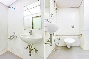 a bathroom with a sink and a toilet at Hotel Amfahh - Andheri West Railway Station in Mumbai