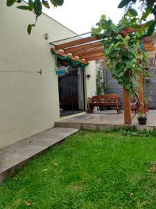 patio con panchina e porta aperta di Casa Aconchegante ou Suítes Privativas a Canela