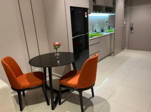 eine Küche mit einem Tisch, 2 Stühlen und einem Kühlschrank in der Unterkunft Hill 10 2r1b 3pax Double Tree I-city Hotel Grade in Shah Alam
