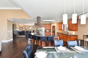a kitchen and dining room with a table and chairs at Nature's Gate Executive Estate in Victoria