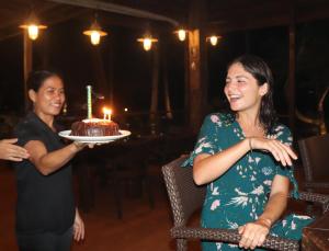 two women holding a cake with a candle on it at Island View Beachfront Resort in Anda +97 photos