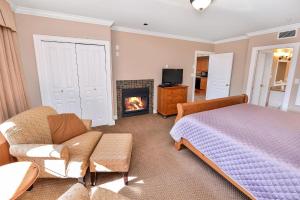 a bedroom with a bed and a fireplace at Miraloma 209 in Sidney