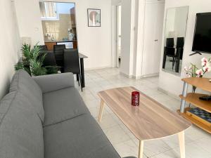 a living room with a couch and a coffee table at Kontheo Elli Ground Apt 2 near the beach in Larnaka