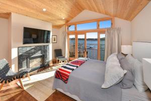 a bedroom with a bed and a fireplace at Salishan Tree House Suite in Cowichan Bay