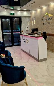 a lobby with a counter and chairs in a store at Sierra Hotel Tbilisi in Tbilisi City