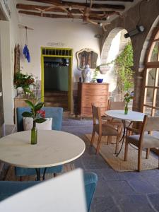 a restaurant with two tables and chairs and a counter at Santa Catalina Hotel Cusco in Cusco