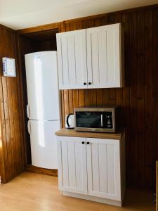 a kitchen with a microwave and a refrigerator at Apartmán Tomáš in Štrbské Pleso +7 photos
