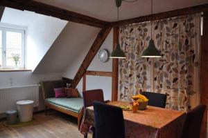 a dining room with a table and a couch at Grundmühle Rhön in Nordheim vor der Rhön