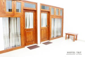 a set of doors and windows in a room at Hotel T & T in Anuradhapura