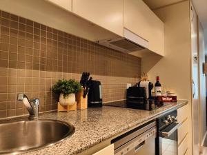 a kitchen with a sink and a counter top at Project BNB at The Bay in Glenelg