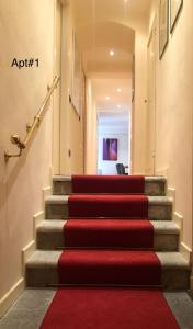 a red carpet on the stairs in a hallway at Casa Cenami in Lucca +12 photos