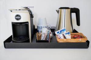 a coffeemaker and a coffee maker and a tea pot at Villa Amelia Rooms in Marina di Pietrasanta