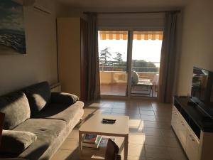 a living room with a couch and a table at Swimming Apartment in Rijeka