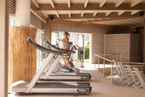 a woman on a treadmill in a gym at Esperos Mare Resort in Faliraki