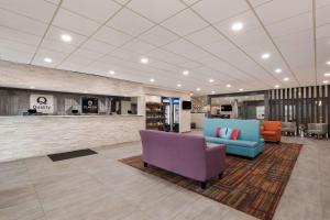a lobby with a couch and chairs in a building at Quality Inn Joliet in Joliet