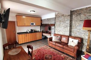 a living room with a couch and a table at Ocean View Madeira 3 - Ponta do Sol in Canhas