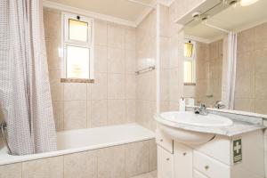 a bathroom with a sink and a tub and a shower at Bela Vista Sea View in Venda do Atalhinho +35 photos