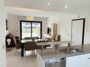 A kitchen or kitchenette at NEW GROUNDFLOOR APT. ARENALES DEL SOL