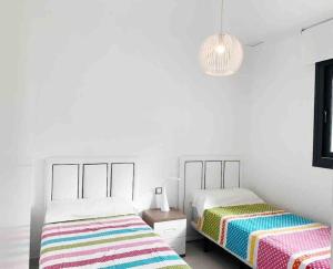 A bed or beds in a room at NEW GROUNDFLOOR APT. ARENALES DEL SOL