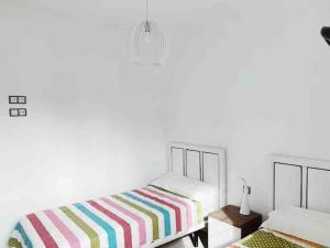 A bed or beds in a room at NEW GROUNDFLOOR APT. ARENALES DEL SOL