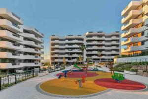 een afbeelding van een appartementencomplex met een speeltuin bij NEW GROUNDFLOOR APT. ARENALES DEL SOL in Arenales del Sol
