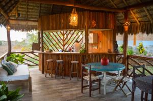 a bar in a resort with a table and chairs at Pousada Theodora in Macapá