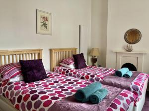 two beds sitting next to each other in a bedroom at Castle Reach in Deal