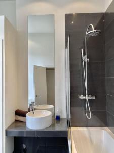 a bathroom with a sink and a shower and a tub at Castle Reach in Deal