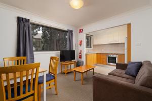 a living room with a couch and a table at Hornsby Furnished Apartments in Hornsby