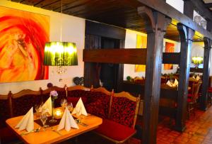 a dining room with a table and chairs in a restaurant at Hotel Haus Krone in Bexbach