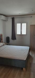 - une chambre avec un grand lit et 2 fenêtres dans l'établissement Le soundoussia, à Pamandzi