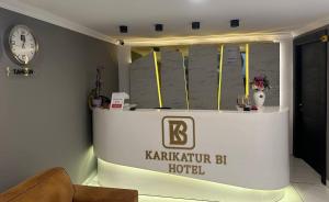 a stage in a hotel with a clock on the wall at Karikatür Bi Hotel in Alanya