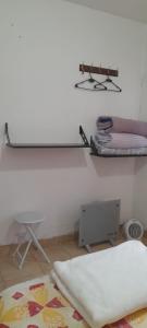 a room with a bed and a shelf and a pillow at Las Colinas in Salta