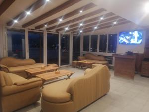 a living room with couches and a flat screen tv at Urban Boutique Hotel Pokhara in Pokhara