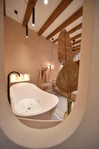 a bathroom with a bath tub in a room at La Loge du Rêveur - Spa - Vieux-Lyon in Lyon